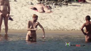 Long haired hottie lays around nude at the  plage-5
