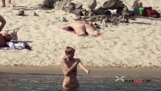 Long haired hottie lays around nude at the  plage-7