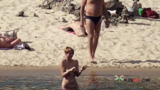 Long haired hottie lays around nude at the  plage-8