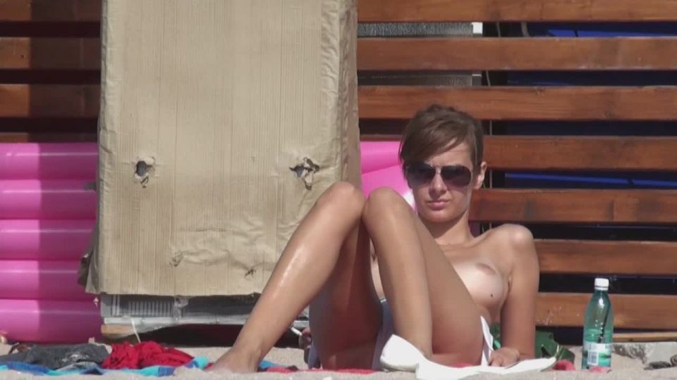 Topless girl smokes a cigarette - Young babe