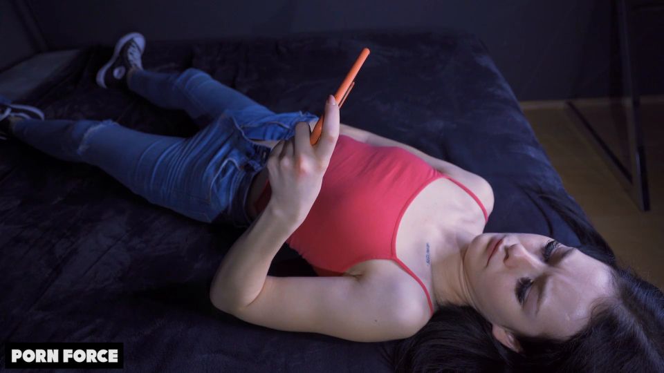 Cute horny girl watching phone porn and fingering pussy on the bed - Amateur