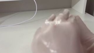 Dildo I give a handjob to the dildo with oily hands in medical white gloves-0