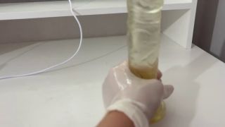 Dildo I give a handjob to the dildo with oily hands in medical white gloves-3