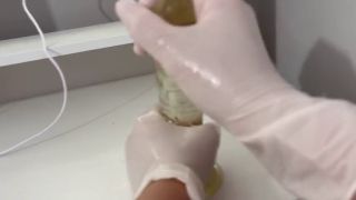 Dildo I give a handjob to the dildo with oily hands in medical white gloves-5