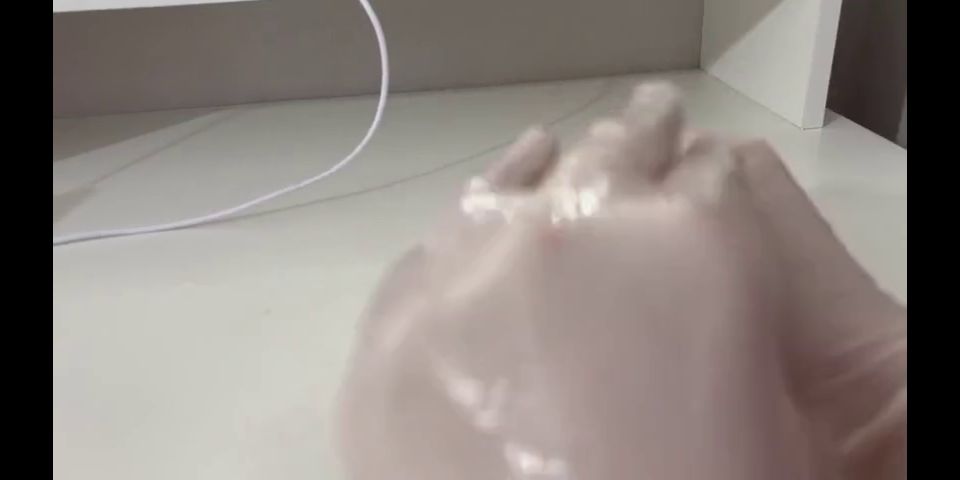 Dildo I give a handjob to the dildo with oily hands in medical white gloves