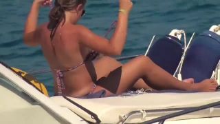 Downblouse - blonde teen flashing her small white boobs tanning on boat - voyeur - blonde porn -0