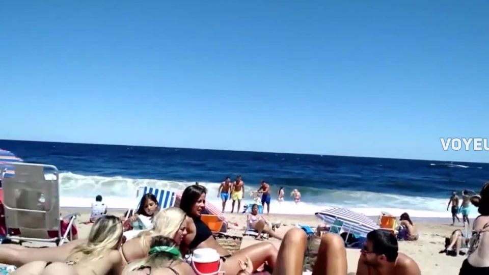 Walking around a circle of stunning babes on beach