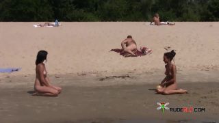 Young nudist friends naked together at the  beach-9