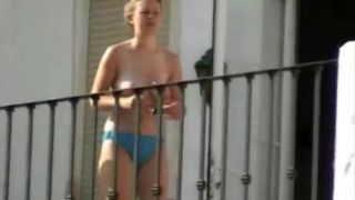 Topless lady on balcony in holiday resort-6