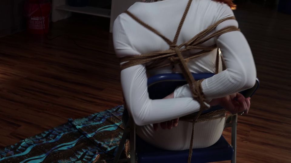 Kimberly Jay all dressed in white gets tied to a chair and gagged.